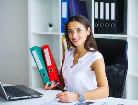 Brunette woman looking at phone while working