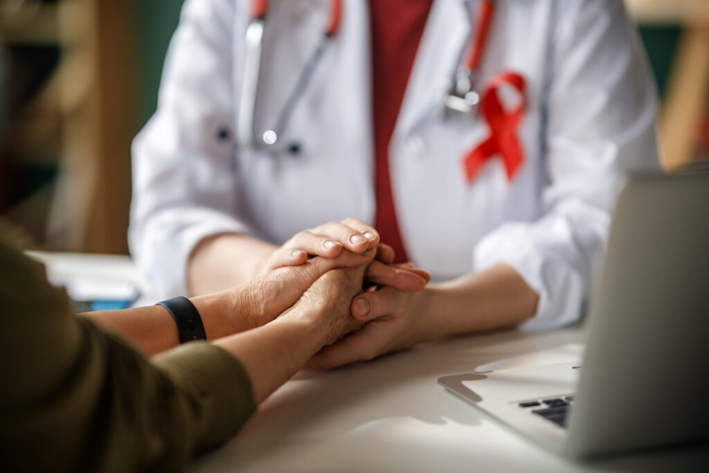 Caring Doctor Comforting Patient with Hands in Medical Office, H